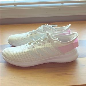 Woman’s white adidas shoes